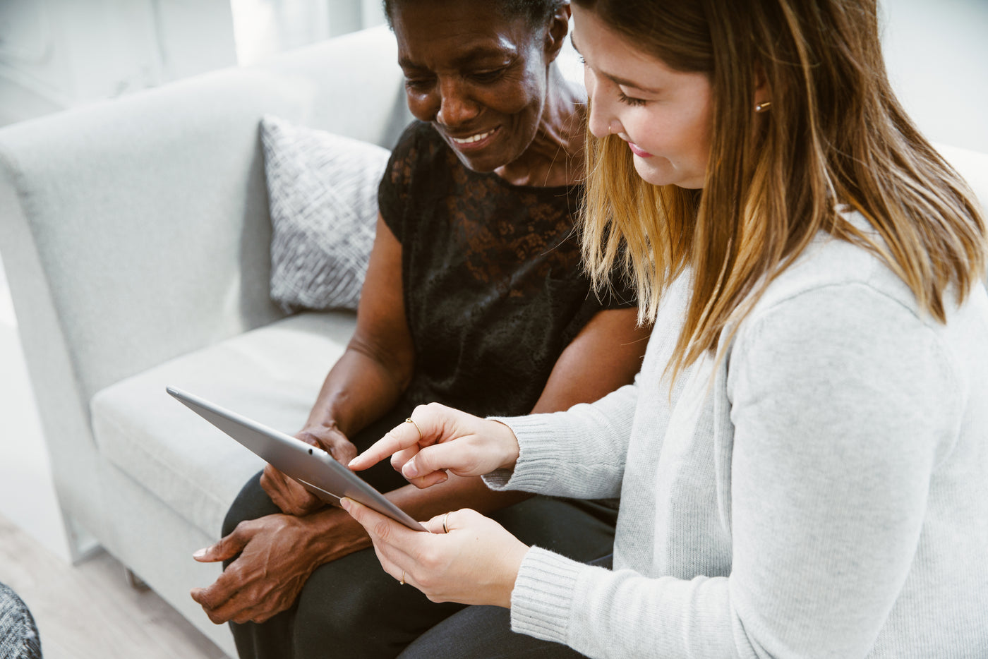A happy senior being helped by a caregiver